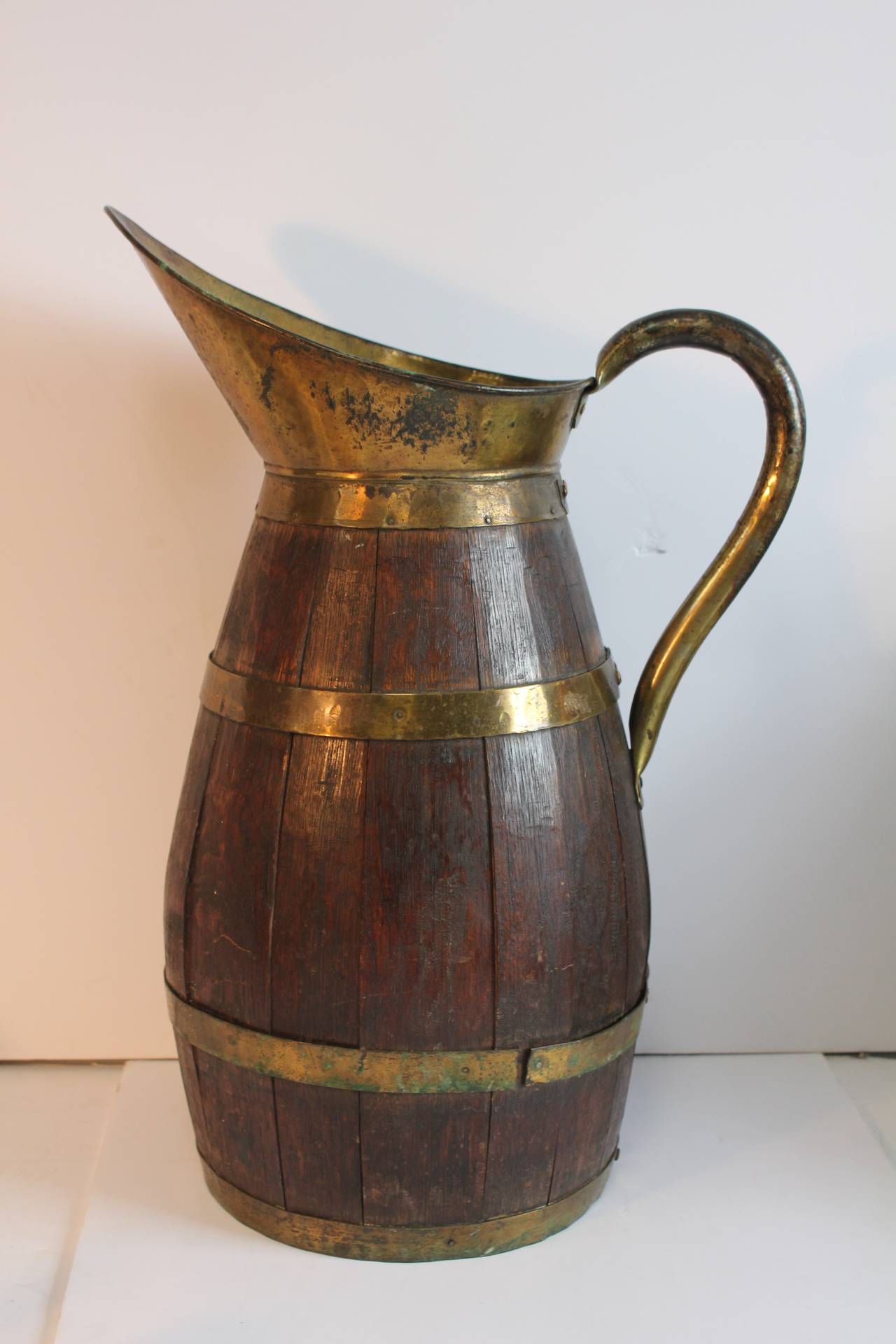Large antique French wood barrel shaped pitcher with brass elements.