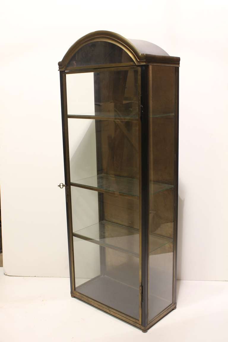 Elegant vintage Italian brass curio cabinet with three glass shelves. It can be hang on the wall. Spacing between shelves from the top to the bottom: H 9.75