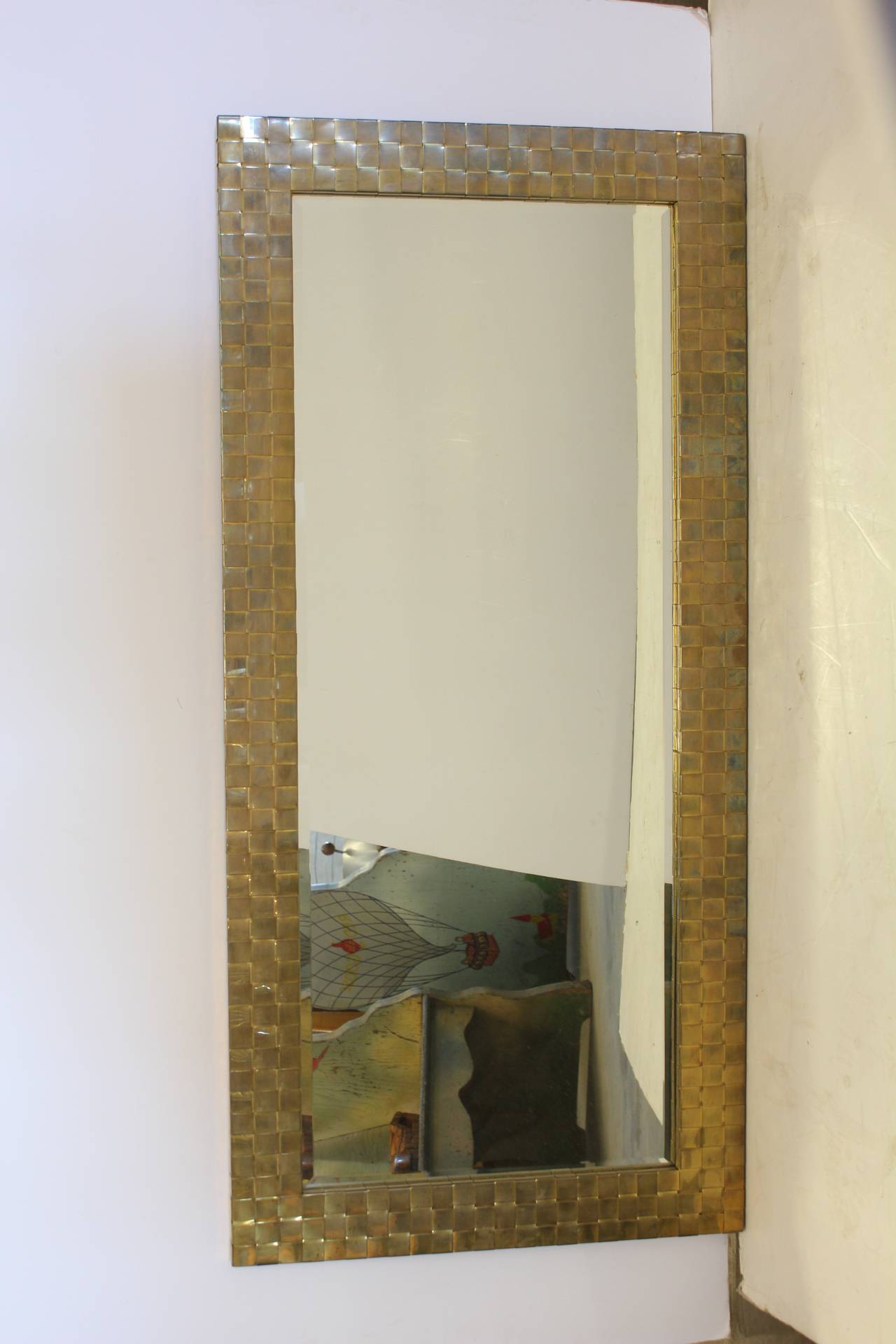 Stylish Mid-Century brass mirror with beveled glass. Hanging hardware included.
