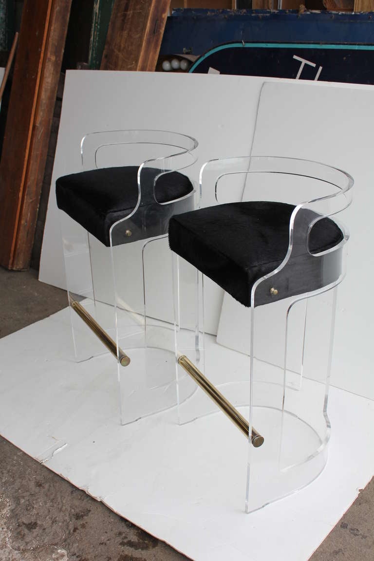 Mid Century Lucite Bar Stools with new black cowhide seats.