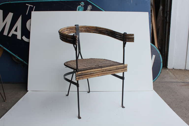 Vintage iron chair with wicker seat and bamboo back accent armchair.