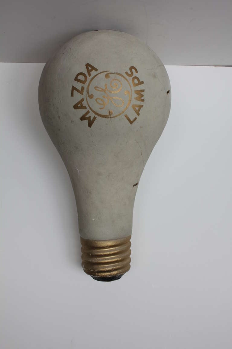 Over sized hand made paper mache bulb prop by General Electric for Mazda Lamps.