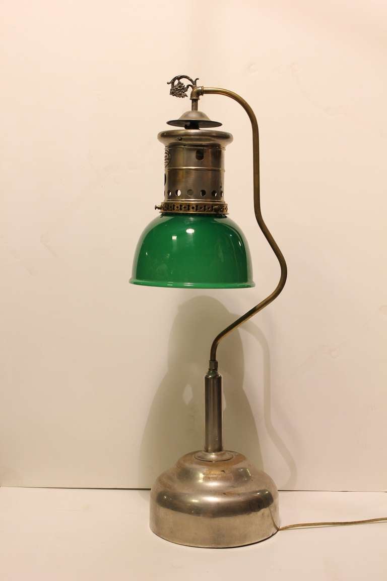 Antique desk lamp with original glass shade. This lamp was turned from gas lamp to electrical lamp. In working condition.