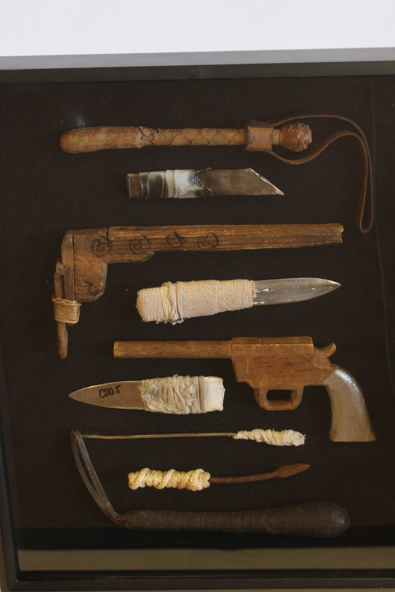 Vintage collection of nine prison shivs and weapons framed in shadow box.