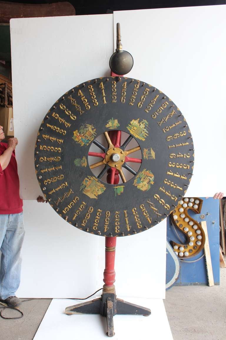Antique hand painted light up game wheel on the stand.