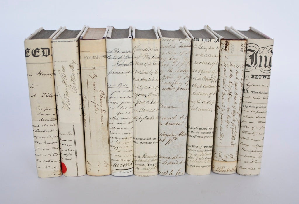 Random vintage books covered with antique law documents and antique prints.