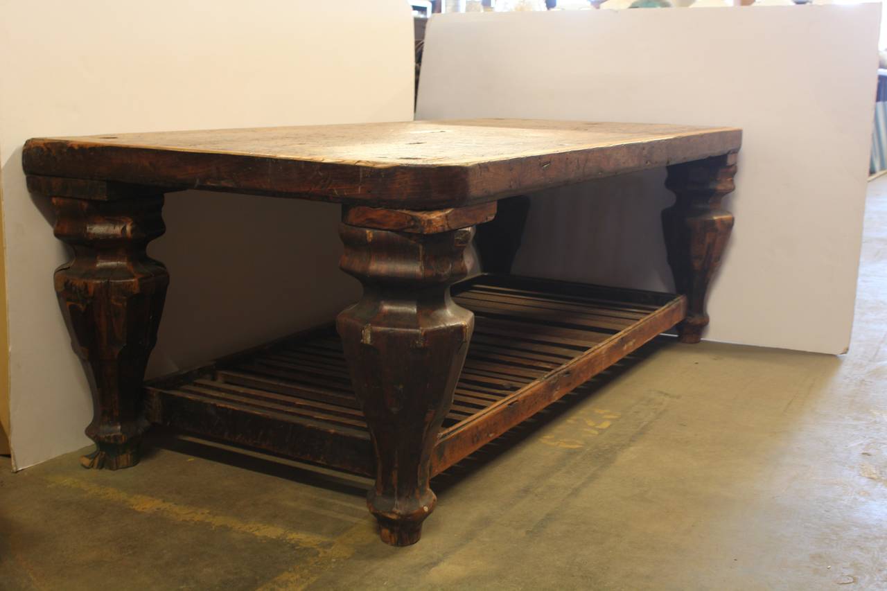 Antique library wood table on coasters.