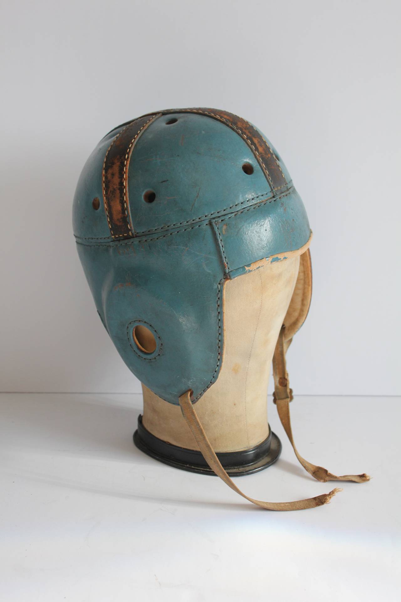 Antique football leather helmet with canvas hat mold.