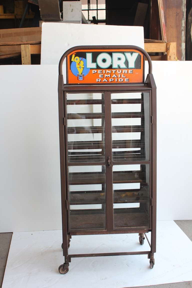 Great antique French double sided advertising metal cabinet with double glass doors and porcelain sign. It came from Paris.