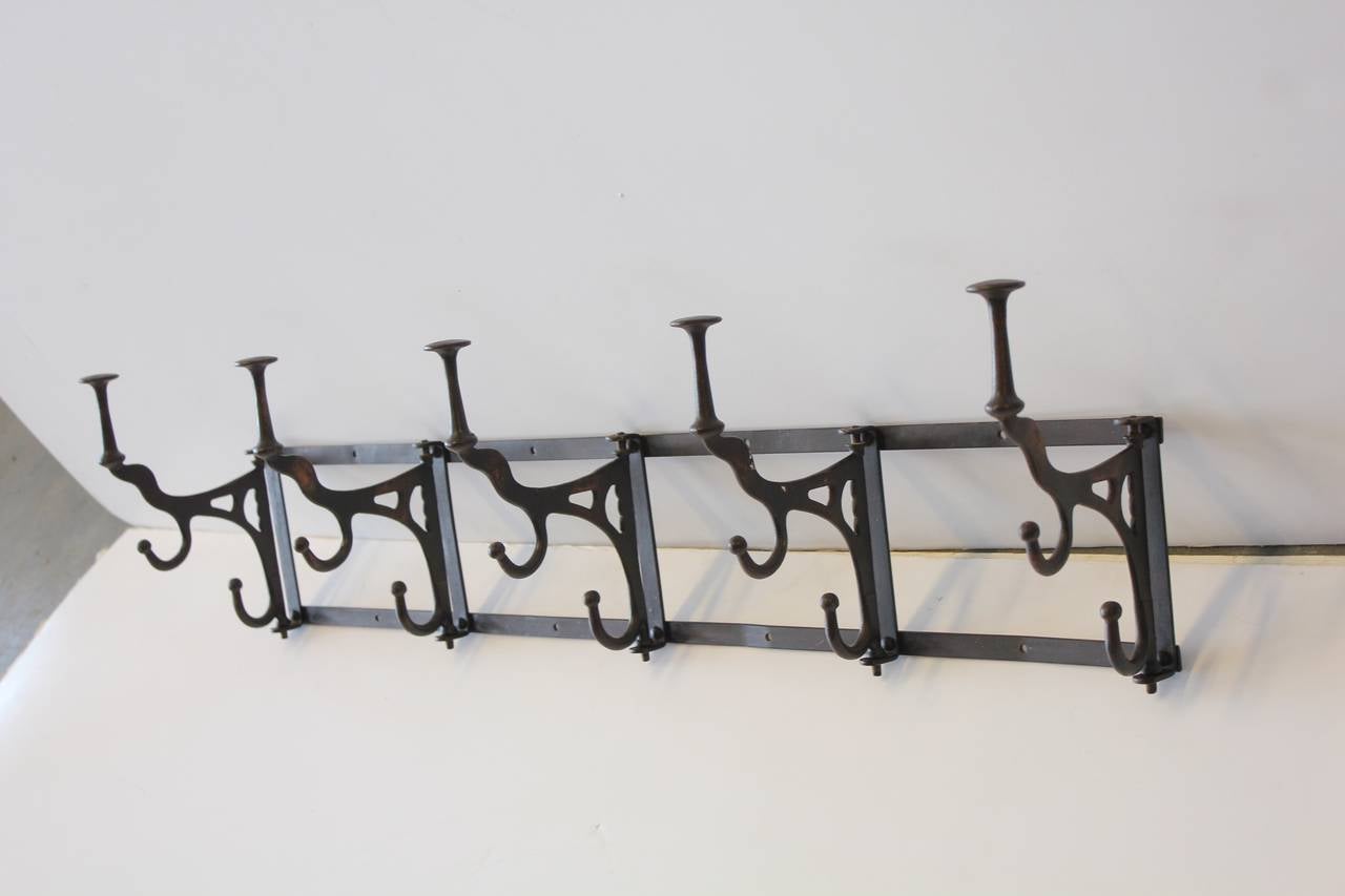 Antique coat and hat rack in copper flush finish.