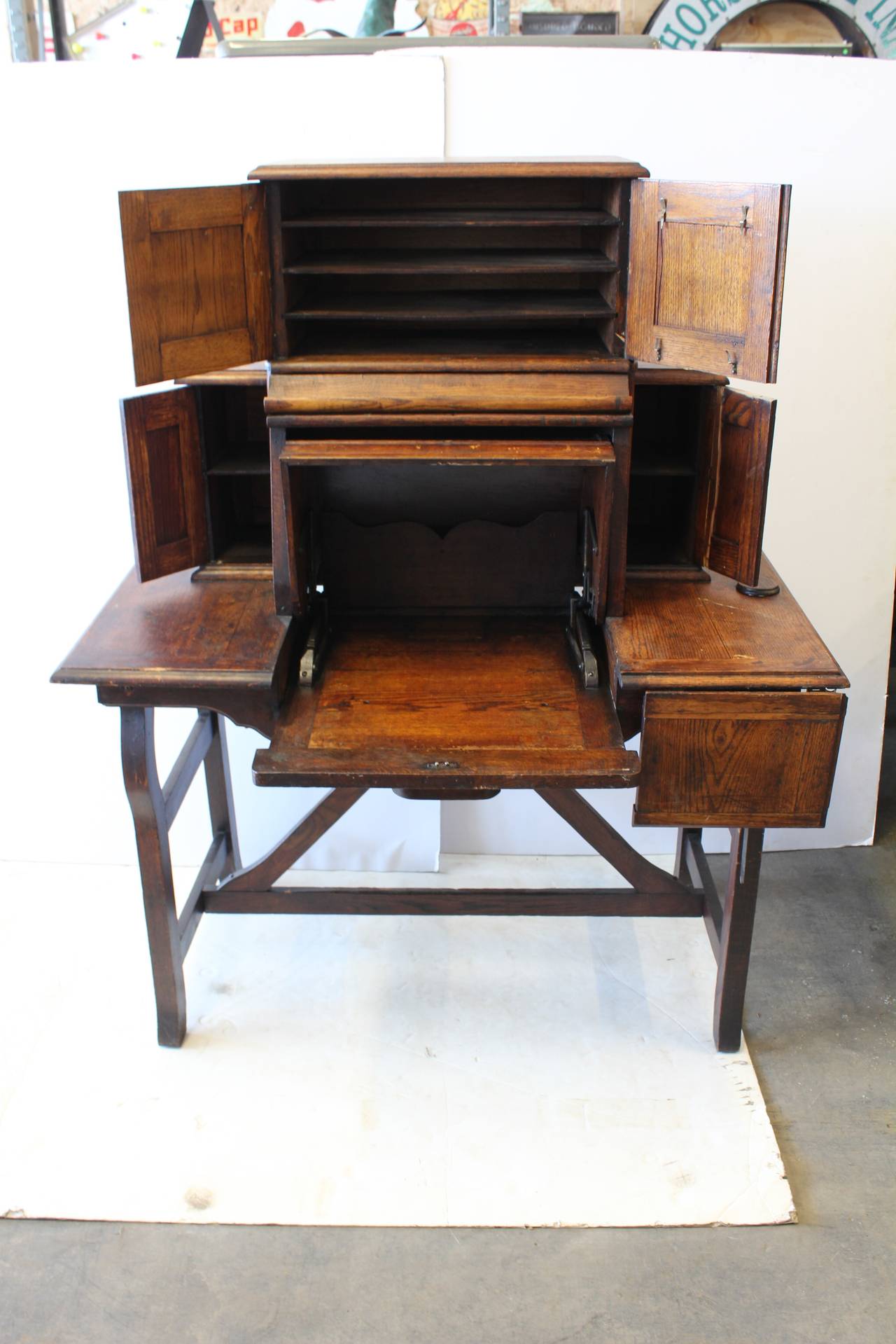 Rare antique American Industrial mechanical desk. By pulling central drawer whole desk will open. The opening H 14