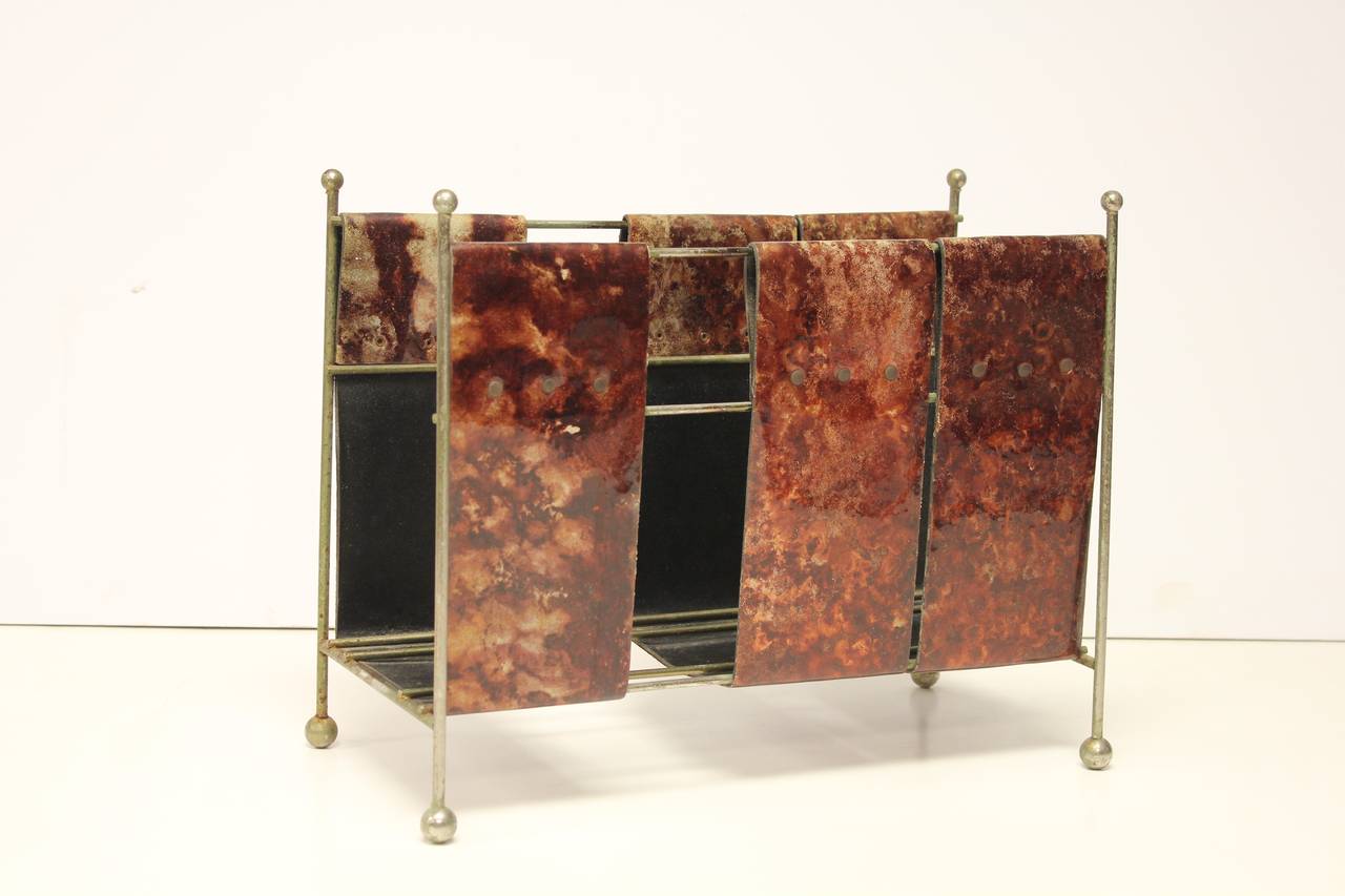Italian Aldo Tura Mid-Century magazine rack made of lacquered leather with metal base.