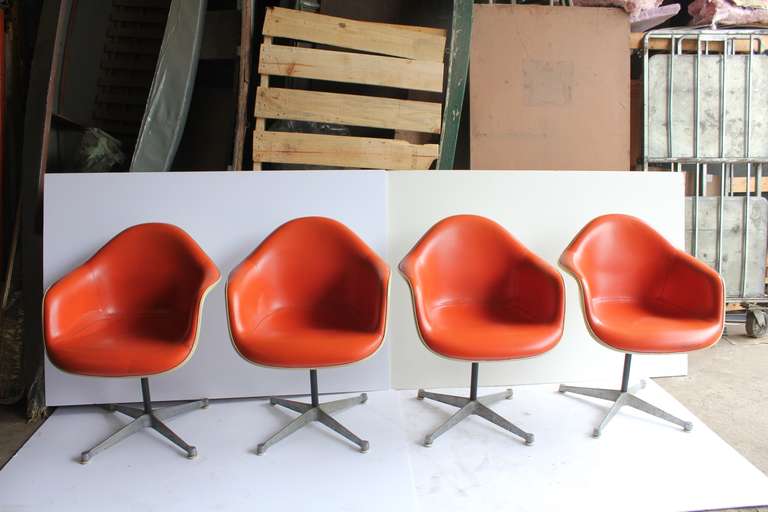 Original 1970s, fiberglass and vinyl chairs designed by Charles Eames for Herman Miller.
