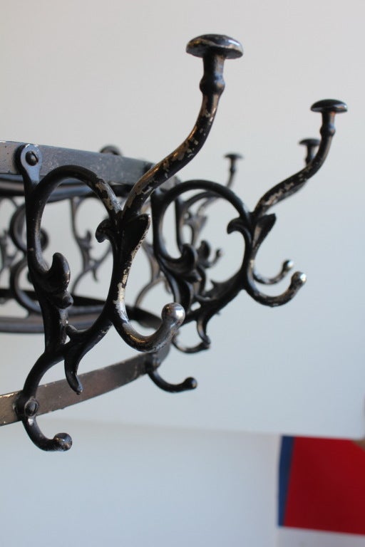 1900's Carrousel Commercial Coat Rack with cast iron base.