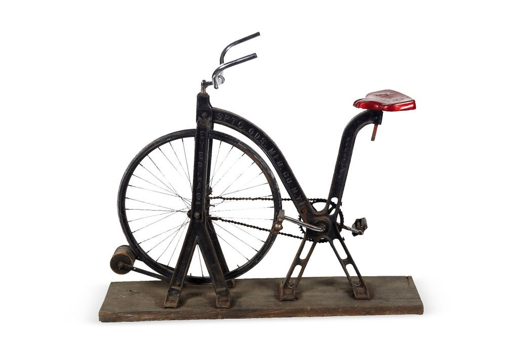 Exercise iron bike on wooden base. Circa 1900.