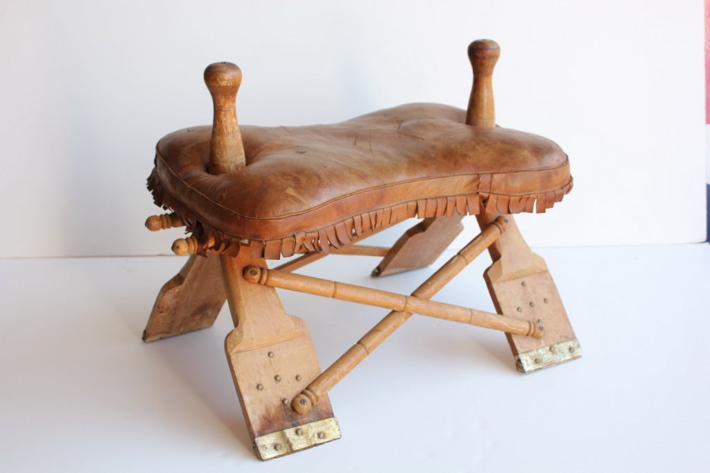 Vintage leather Camel Saddle stool with leather seat.