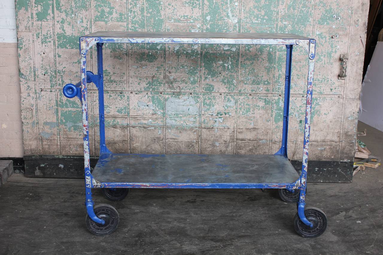 Vintage American metal bar cart with two glass shelves.