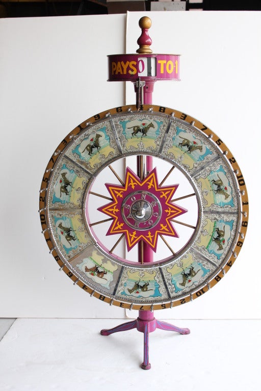 1900's Counter top Horse Betting Game wheel with odds changer,cast iron base and mirrored design with horses and riders images. Made by Mason & Co.