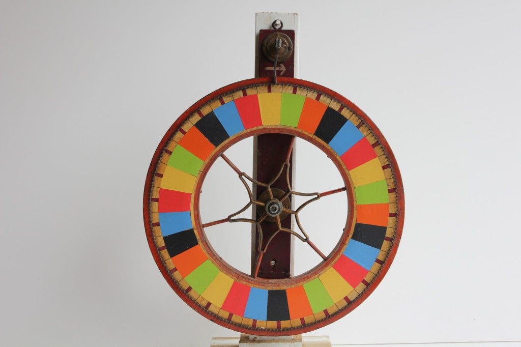 1900's American Folk Art Carnival hand painted double sided Game wheel.It still spins perfectly. It has a wooden stand, but it can be also hang on the wall.