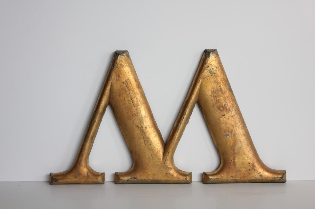 Great 1920's cast iron letter W painted in gold leaf tone. It came from F. W. Woolworth department store.