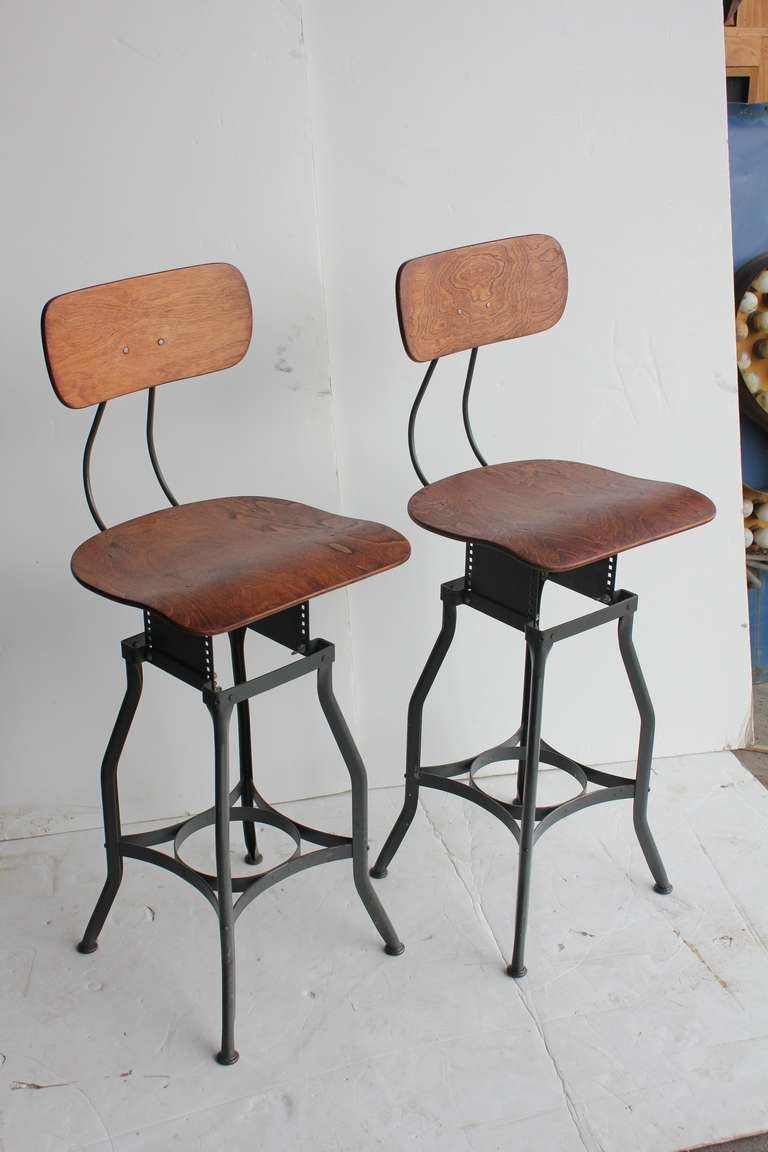 Vintage original American Toledo stools with refinished wooden back and seat. Seat H adjustable from 22