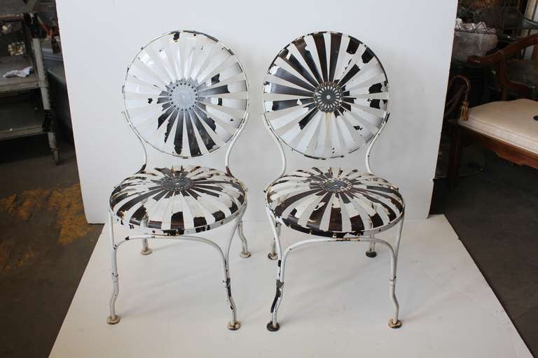1930's French garden chairs designed by Francois Carre. Each chair  with sunburst seat and back with button centers. Listed price is for each chair.