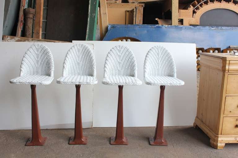 1930's Ice Cream Parlor stools with wicker seat and porcelain bases.