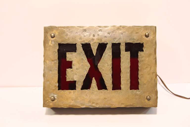 Early 1900's hammered brass and red glass light up EXIT sign. In working condition. We have two available. Listed price is for one light.