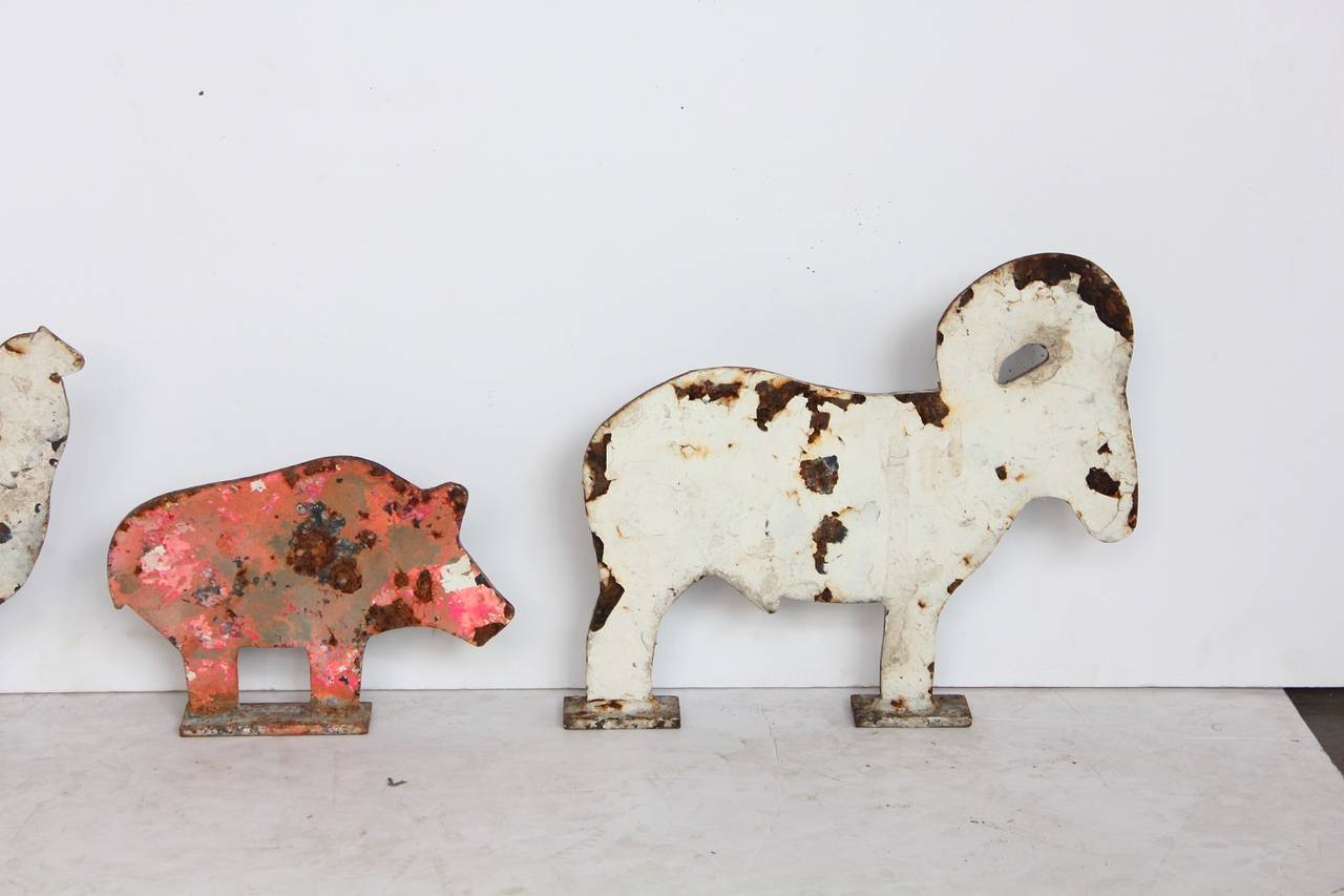 Collection of four 1920s cast iron carnival shooting gallery targets. Pig: H 6