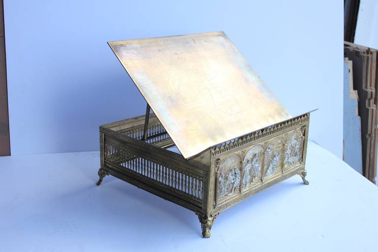 Antique decorative gilt brass bible or book stand. The top lifts up with an adjustable easel support underneath.