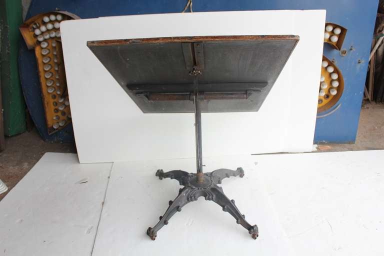 Antique original American Tilt top table with decorative cast iron base. Wooden top 41.75