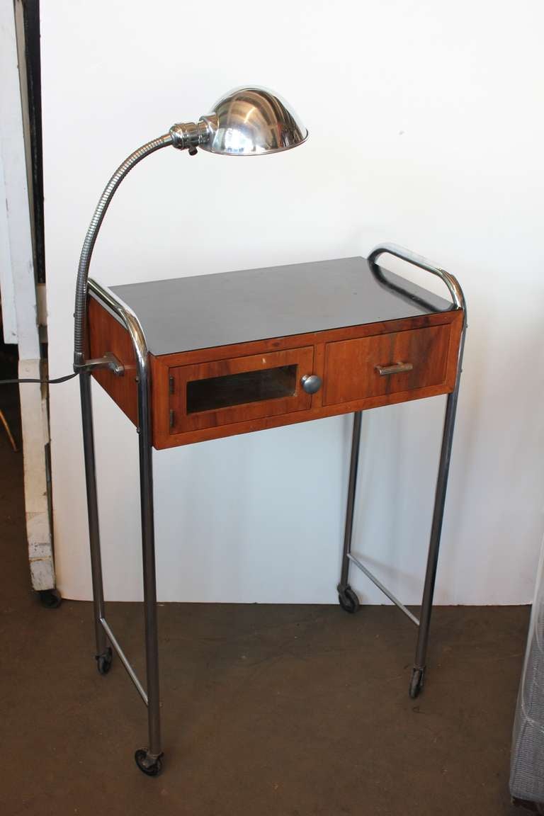 1930's original Art Deco medical table/desk on wheels with original attached light.