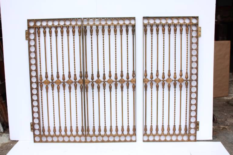Antique ornate solid bronze three panel gate.