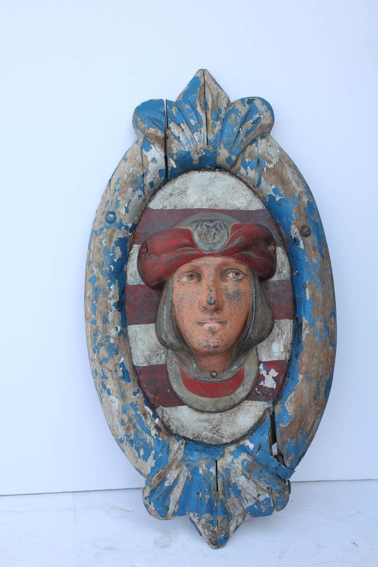 1930s handmade Merry Go Round decoration plaque with wooden frame and cast iron face.