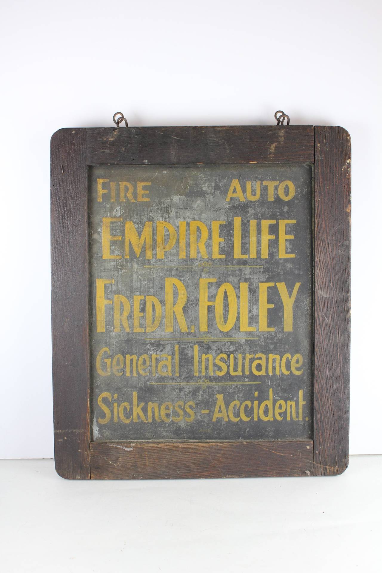 Antique double sided hand painted tin insurance sign framed in original frame.