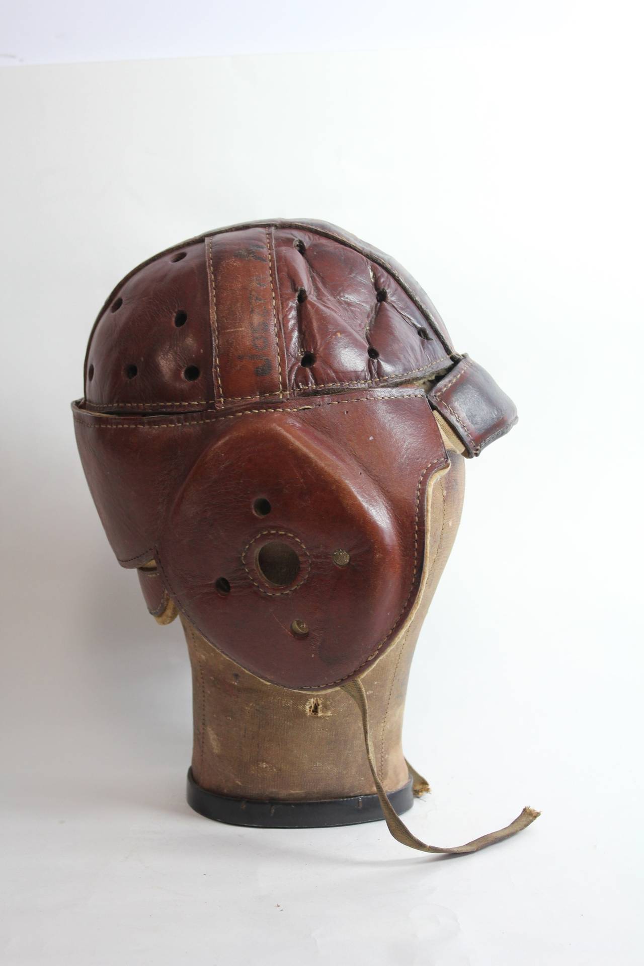 Antique football leather helmet with canvas hat mold.
