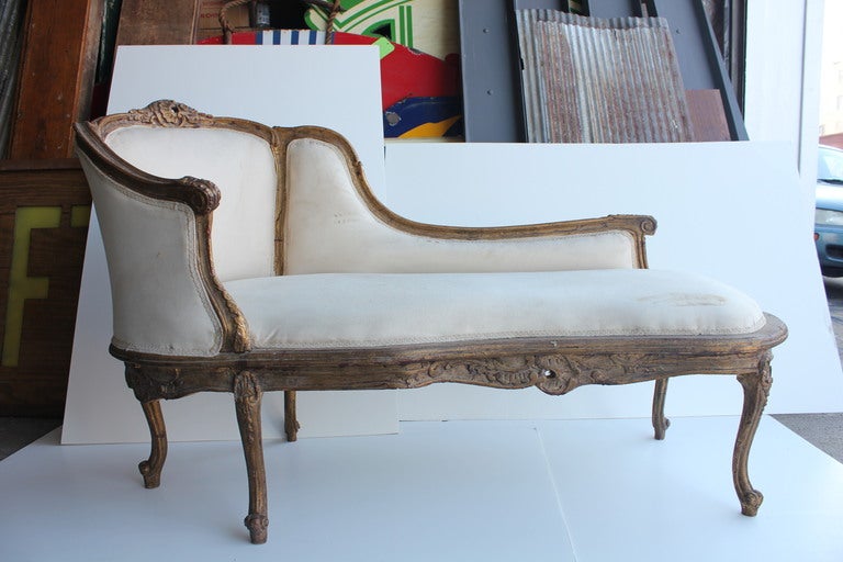 19th Century French chaise lounge with hand carved base and cotton upholstery.