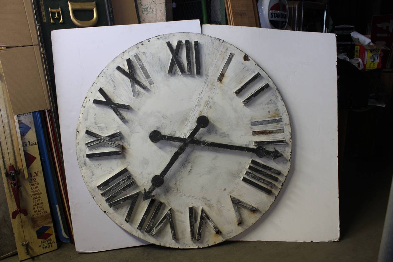 Antique approx. 5 ft diameter tin clock face attached to wooden board.