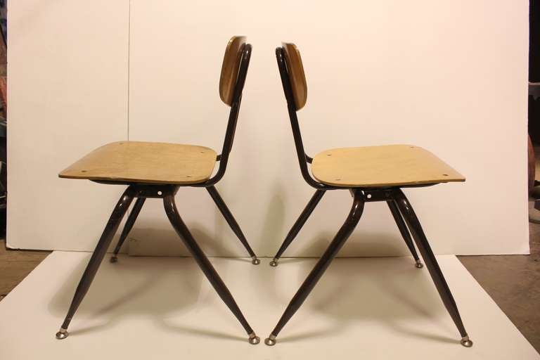 Mid Century school chairs with metal base and wood seat and back. Large quantity available. Listed price for one chair.