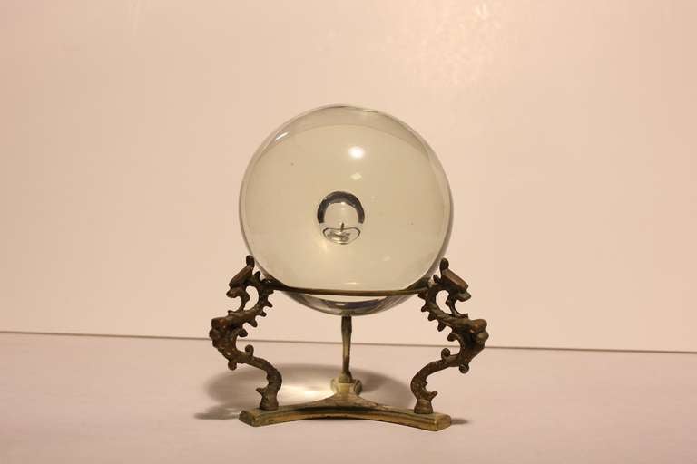 Italian Murano large glass ball with brass dragon design stand.