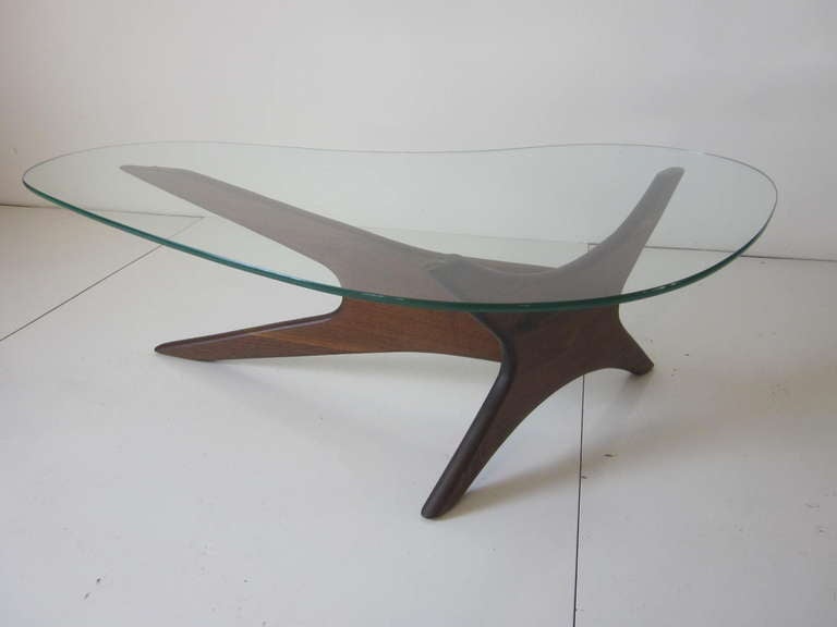 A solid walnut based coffee table with a biomorphic glass top that has a sculptural style in the manner of George Nakashima, manufactured by Craft Associates.