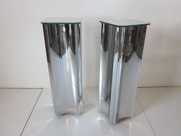 A pair of matching Jere pedestals with thick glass mirrored tops and formed polished chrome bases.