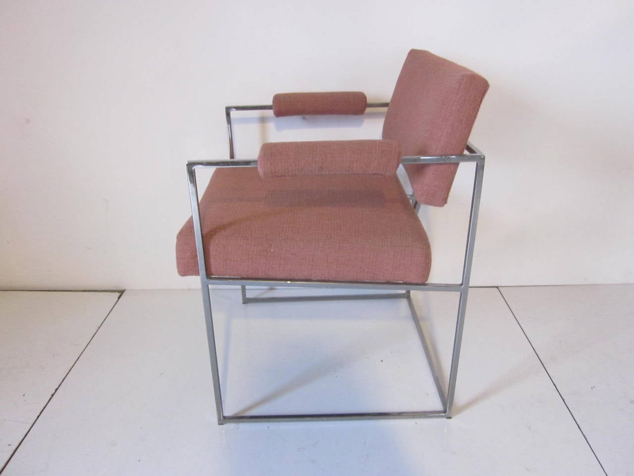 A set of eight Milo Baughman dining chairs with squared chromed tube frames, upholstered seat bottoms, backs and rolled arms. Manufactured by the Thayer Coggin Furniture company.
