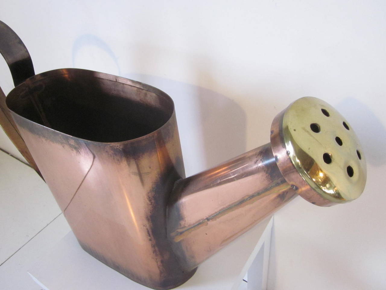 A super large sized Jere watering can with copper body and brass handle and spout. Signed to the lower bottom end Curtis Jere 1981, great for a center piece  spring or summer flower arrangement . This item would need a liner to avoid any possible