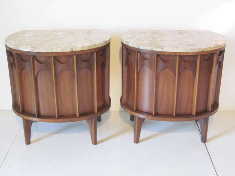 A rare matching pair of walnut and rosewood Brasilia Nightstands / End Tables topped with Italian marble.A front door opens to reveal storage and a small pull out drawer. The line was named after the modern Brazilian city ( Brasilia) and copies some