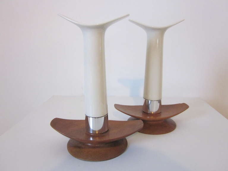 A pair of Towle Danish styled candlesticks with flared walnut bases, sterling silver collars and cream colored porcelain shafts with matching flared design, marks to the collars  .