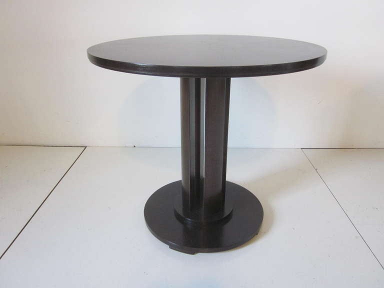 A ebony finished Baker side table/ lamp table with book matched burl wood and heavily grained top sitting on a four post split base , retain the manufactures metal label.