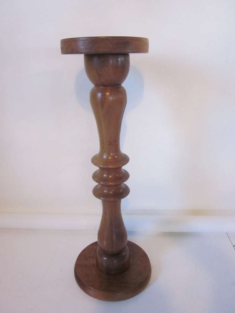 A artist studio handcrafted  pedestal using medium dark walnut in a very modern design. Marked and signed by the artist-Lester Holtz, Clayton ,Del. 1-6-1974 . A piece that brings some nature and warmness back into your living space .
