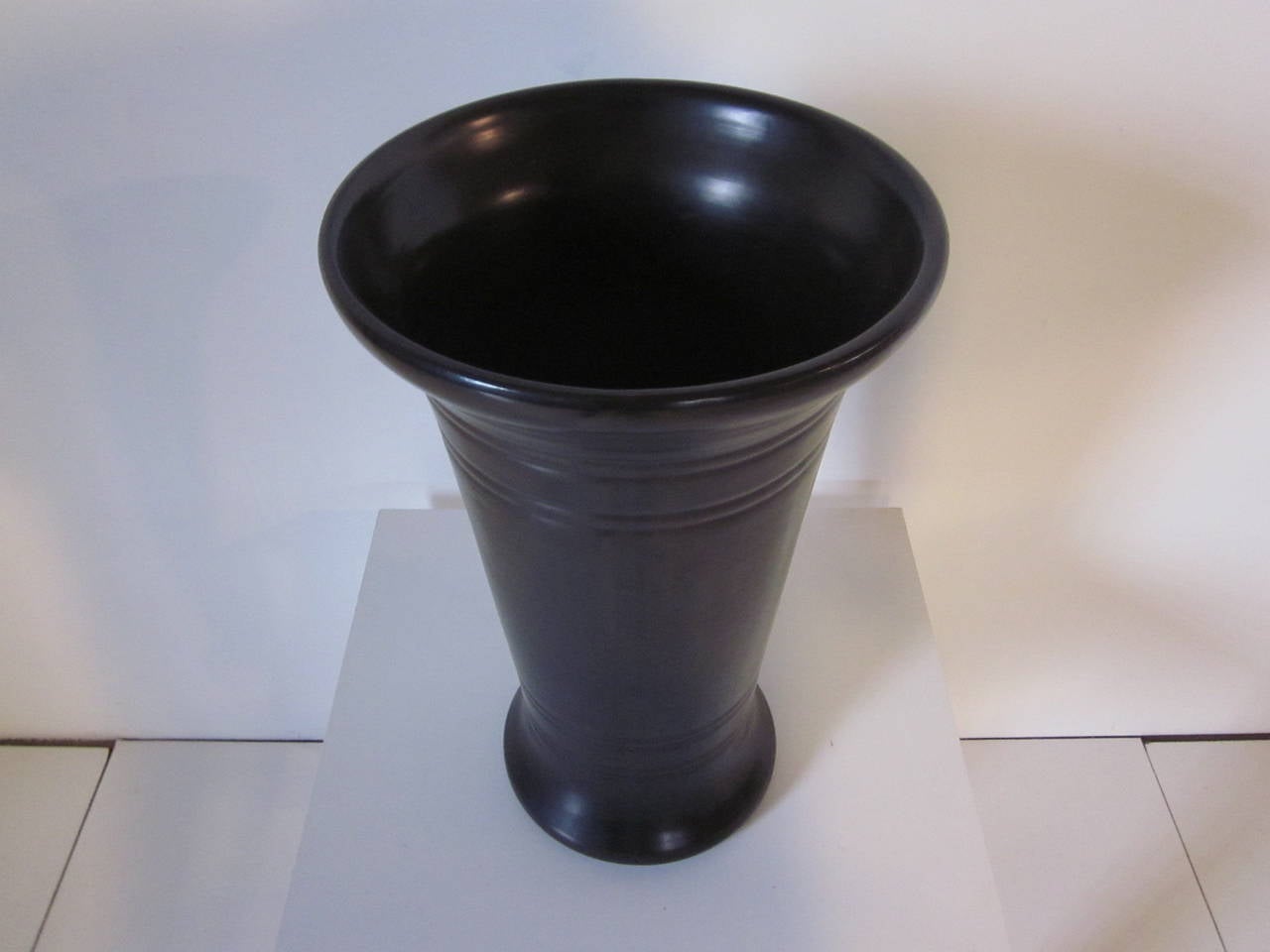 A rare and hard to find black Bauer Pottery umbrella stand with ring pattern, markings to the base 