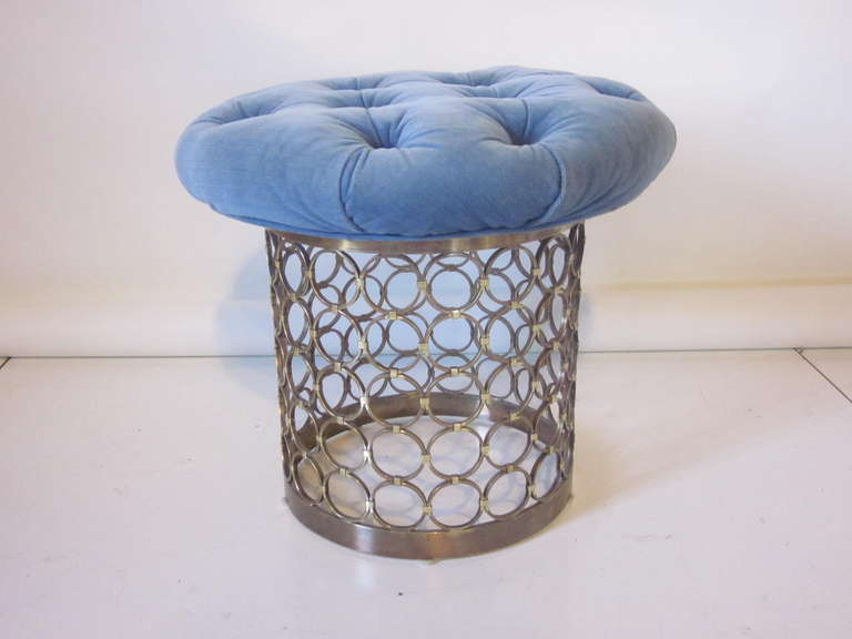 A high quality brass ringed stool with powder blue tufted swiveling top, each brass ring is welded with a connector and nylon feet to the base. Made in the style of Karl Springer .